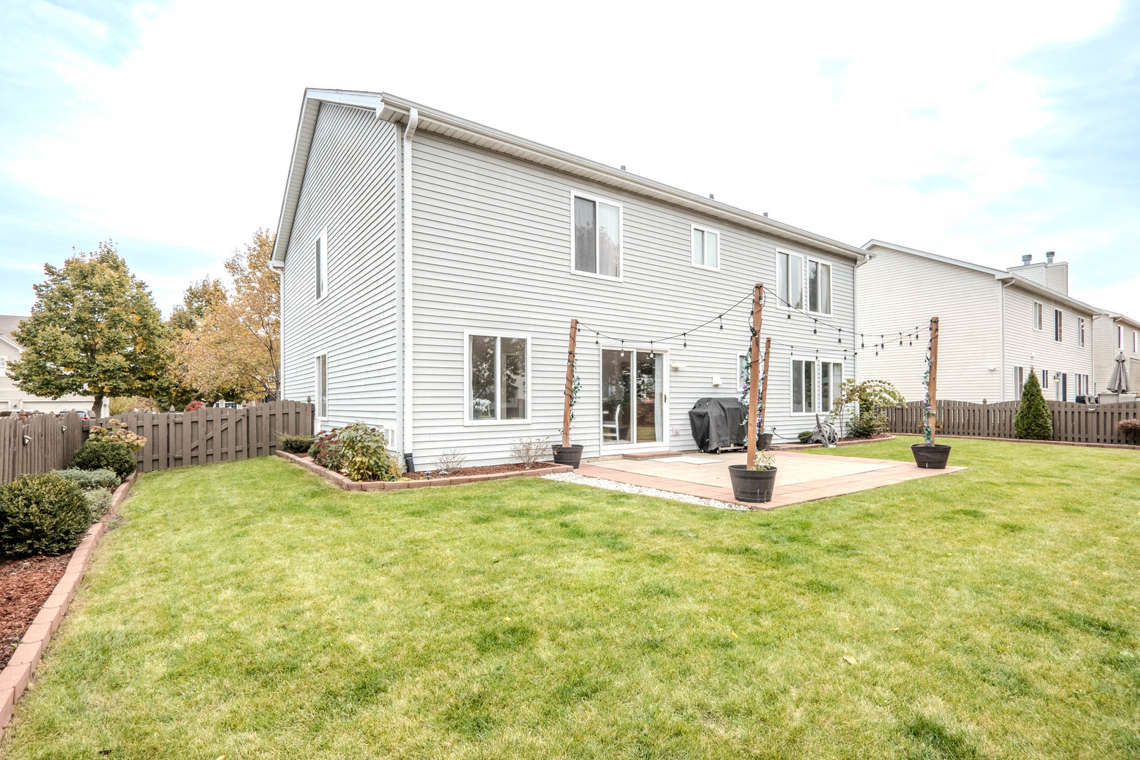 215 Alexis Street Plano, IL 60545 - Photo 34 of 42 a view of a house with swimming pool and a yard