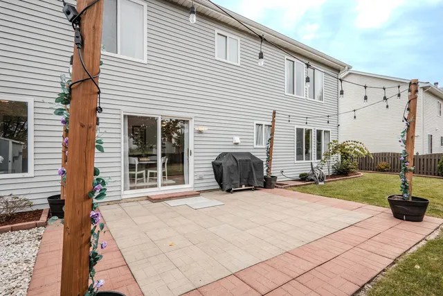 a view of a house with backyard and sitting area