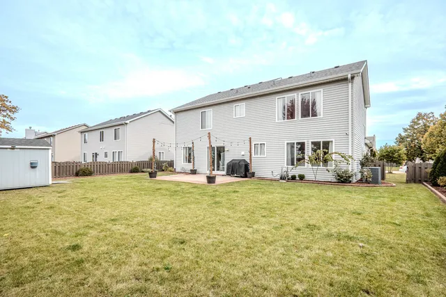 a view of a house with a yard and sitting area