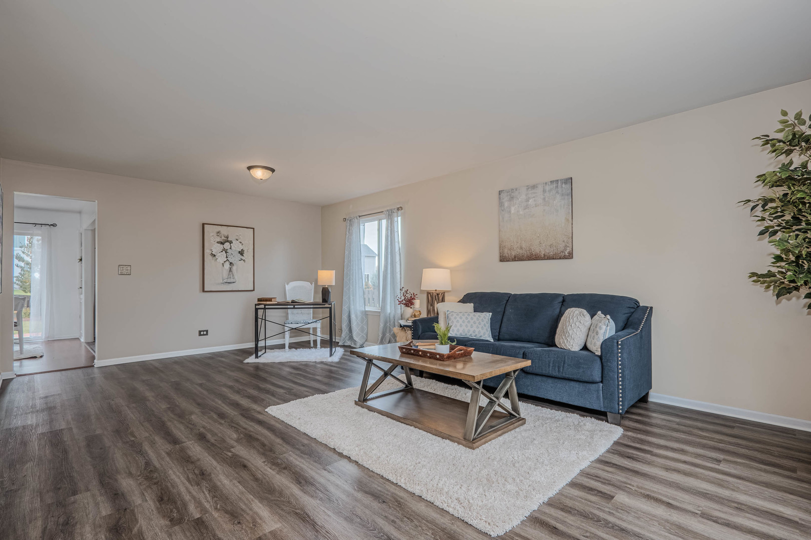 215 Alexis Street Plano, IL 60545 - Photo 5 of 42 a living room with furniture and a wooden floor