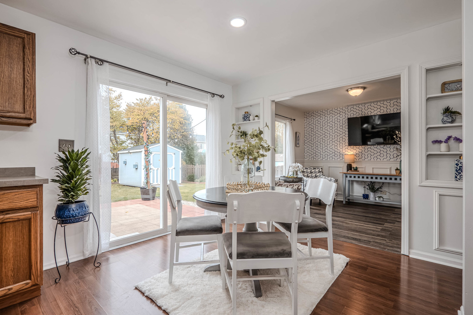 215 Alexis Street Plano, IL 60545 - Photo 10 of 42 a living room with furniture a large window and wooden floor
