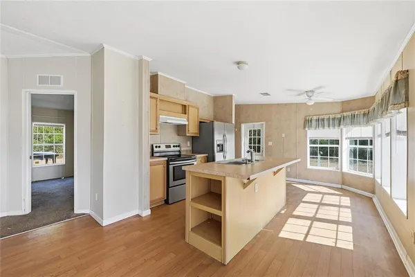 a kitchen with white cabinets and appliances