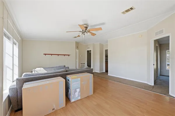 a kitchen with a sink a stove cabinets and wooden floor
