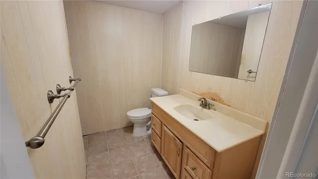 a bathroom with a sink a toilet and mirror