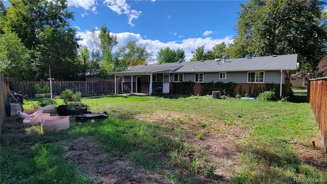 a view of a house with backyard sitting area and garden