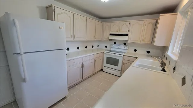 a white refrigerator freezer sitting inside of a kitchen