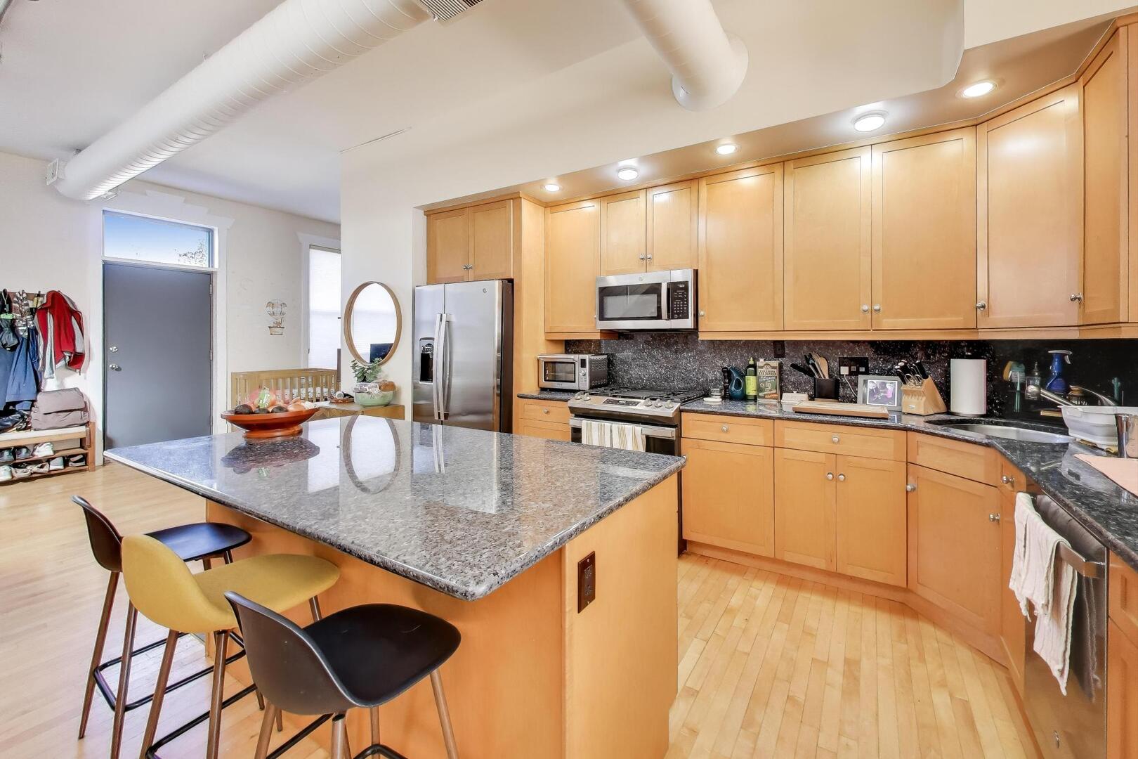 400 North Racine Avenue, Unit 204 Chicago, IL 60642 - Photo 7 of 22 a kitchen with stainless steel appliances granite countertop a stove top oven a sink dishwasher and cabinets with wooden floor