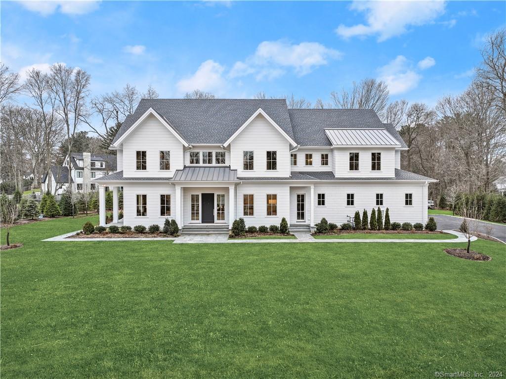 2 Authors Way Westport, CT 06880 - Photo 1 of 1 a front view of a house with a garden and trees