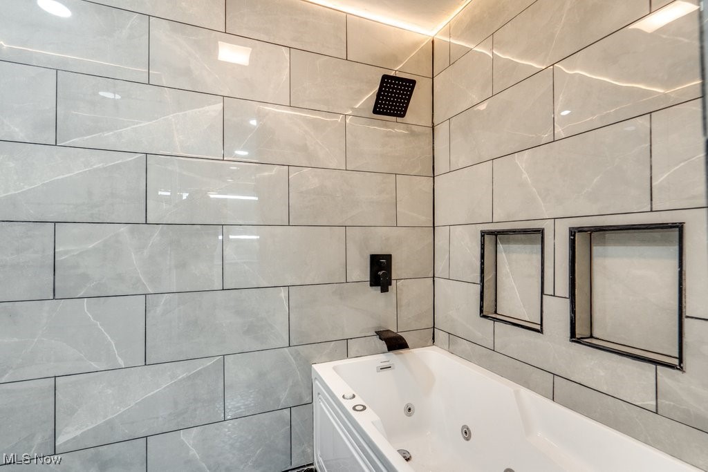 3720 Baird Road Stow, OH 44224 - Photo 18 of 45 Bathroom with tile walls and tiled shower / bath