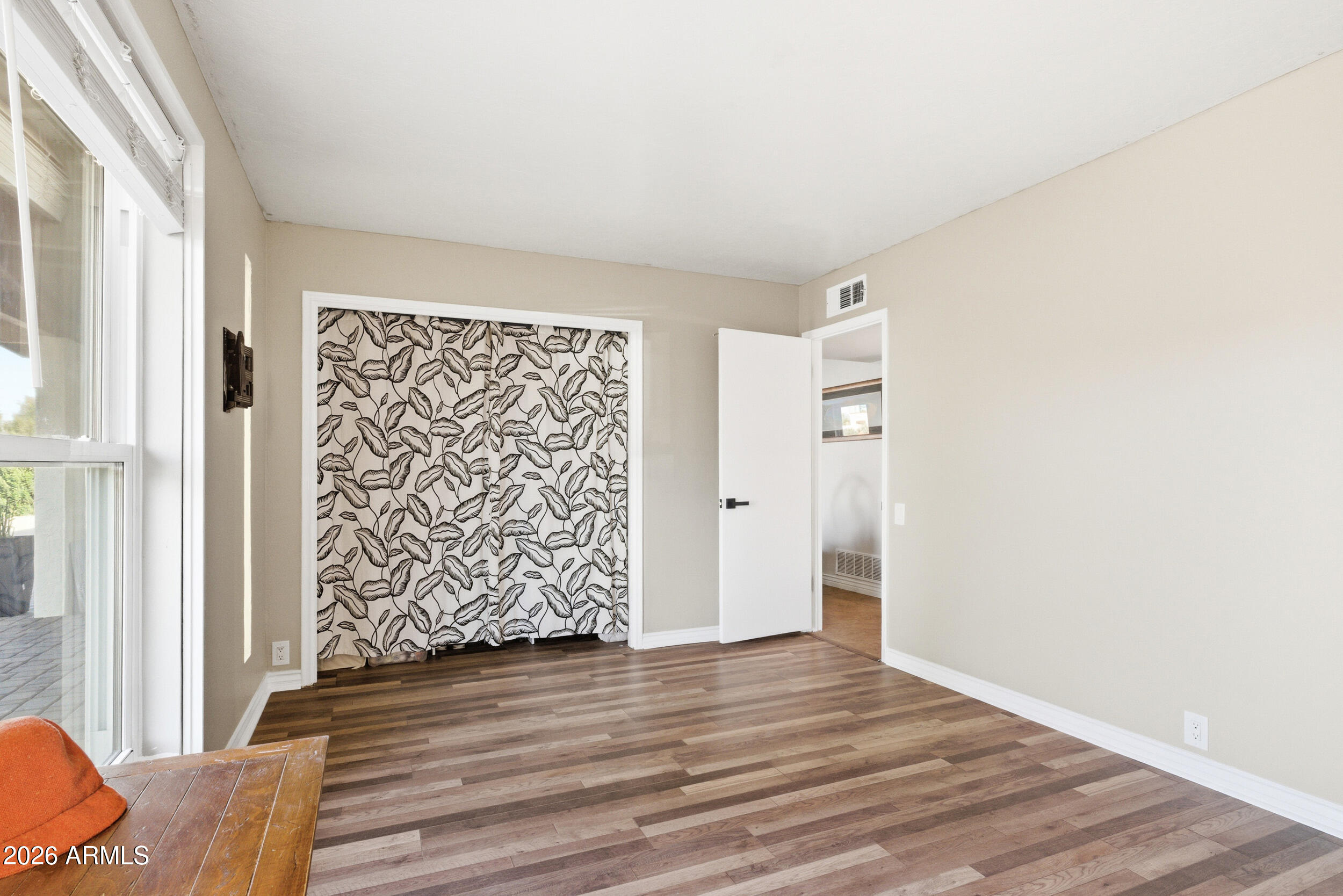 3541 East Cannon Drive Phoenix, AZ 85028 - Photo 11 of 42 a view of an empty room with wooden floor and a window