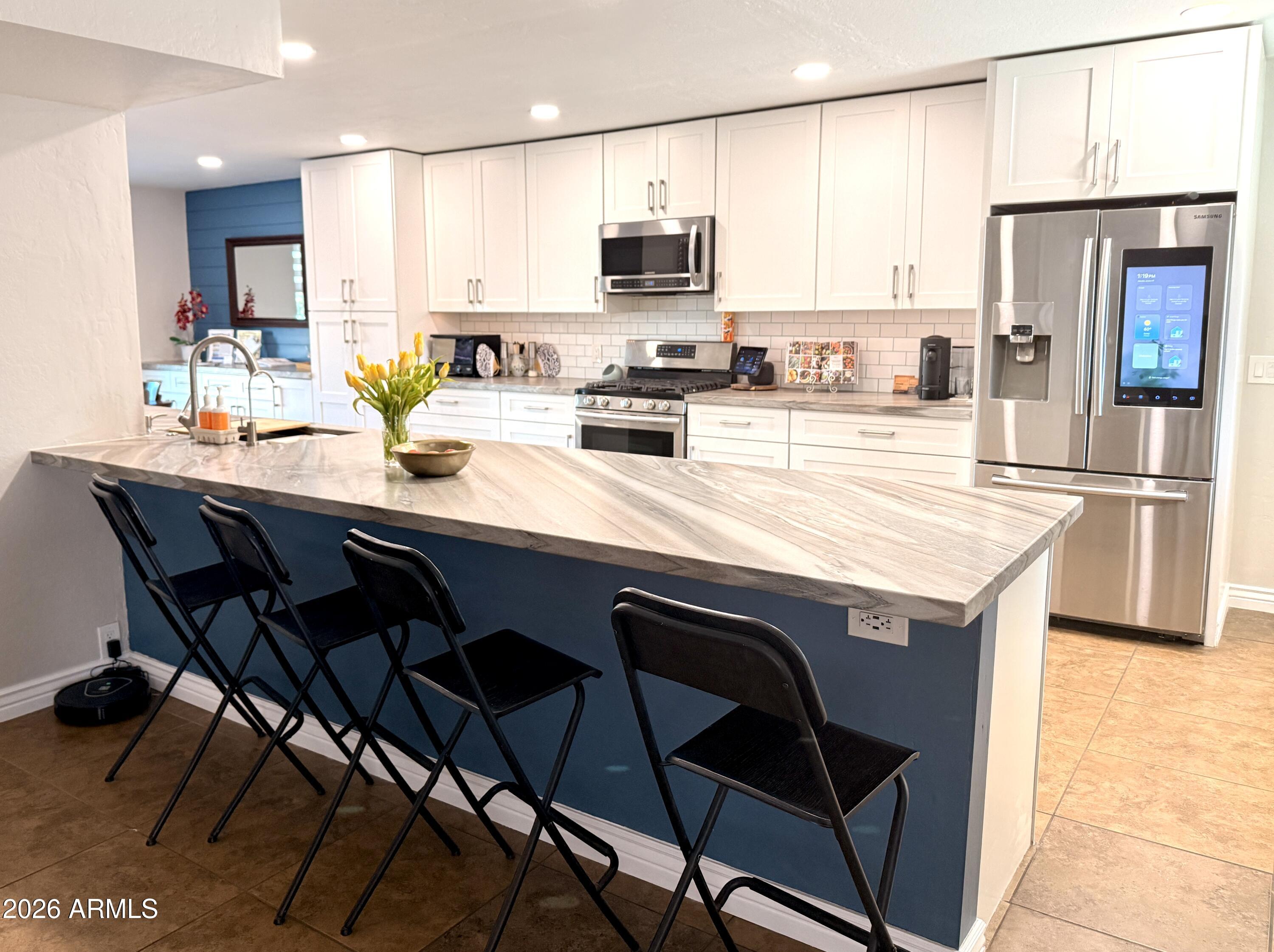 3541 East Cannon Drive Phoenix, AZ 85028 - Photo 14 of 42 a kitchen with a sink cabinets and wooden floor