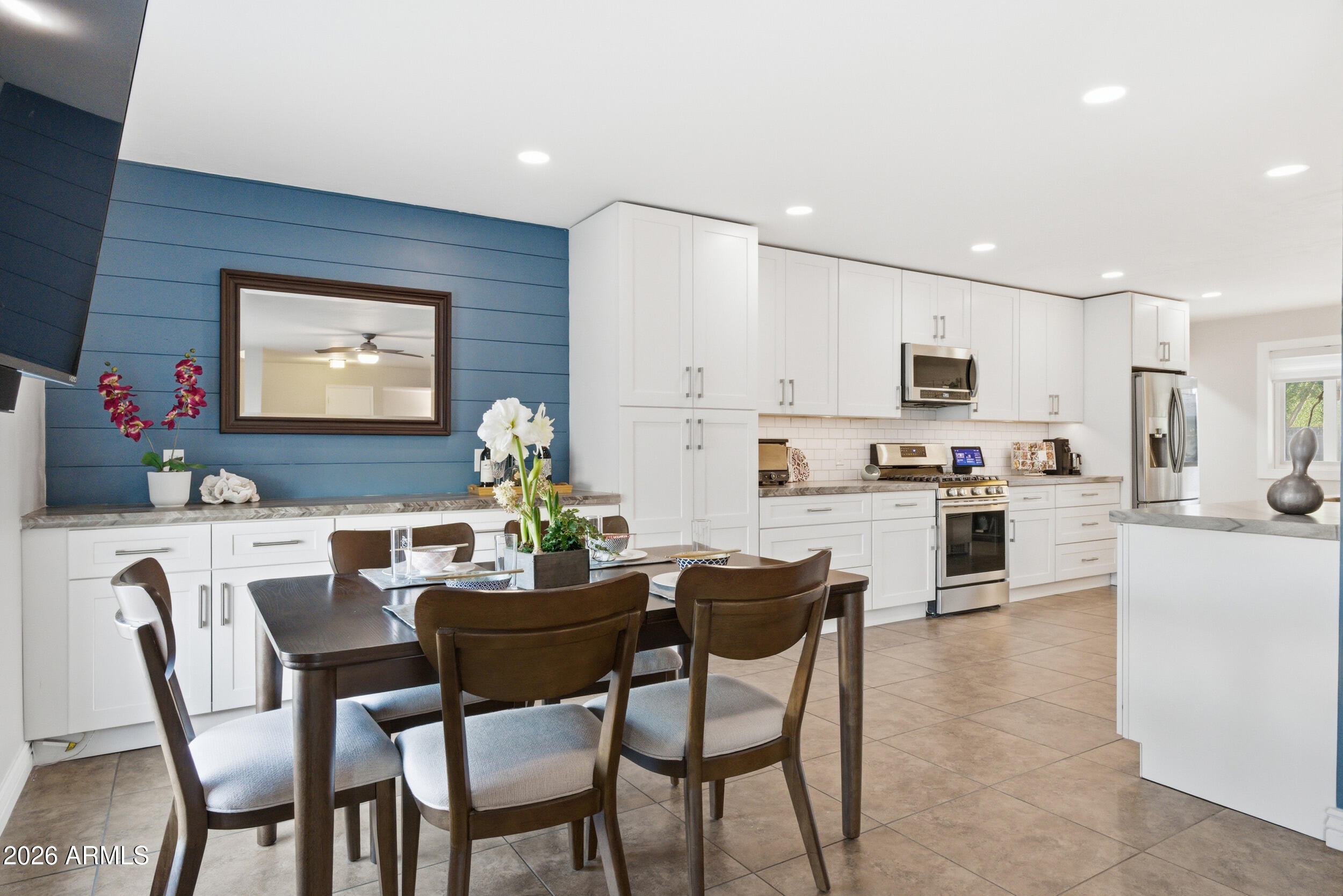 3541 East Cannon Drive Phoenix, AZ 85028 - Photo 17 of 42 a kitchen with kitchen island white cabinets and stainless steel appliances