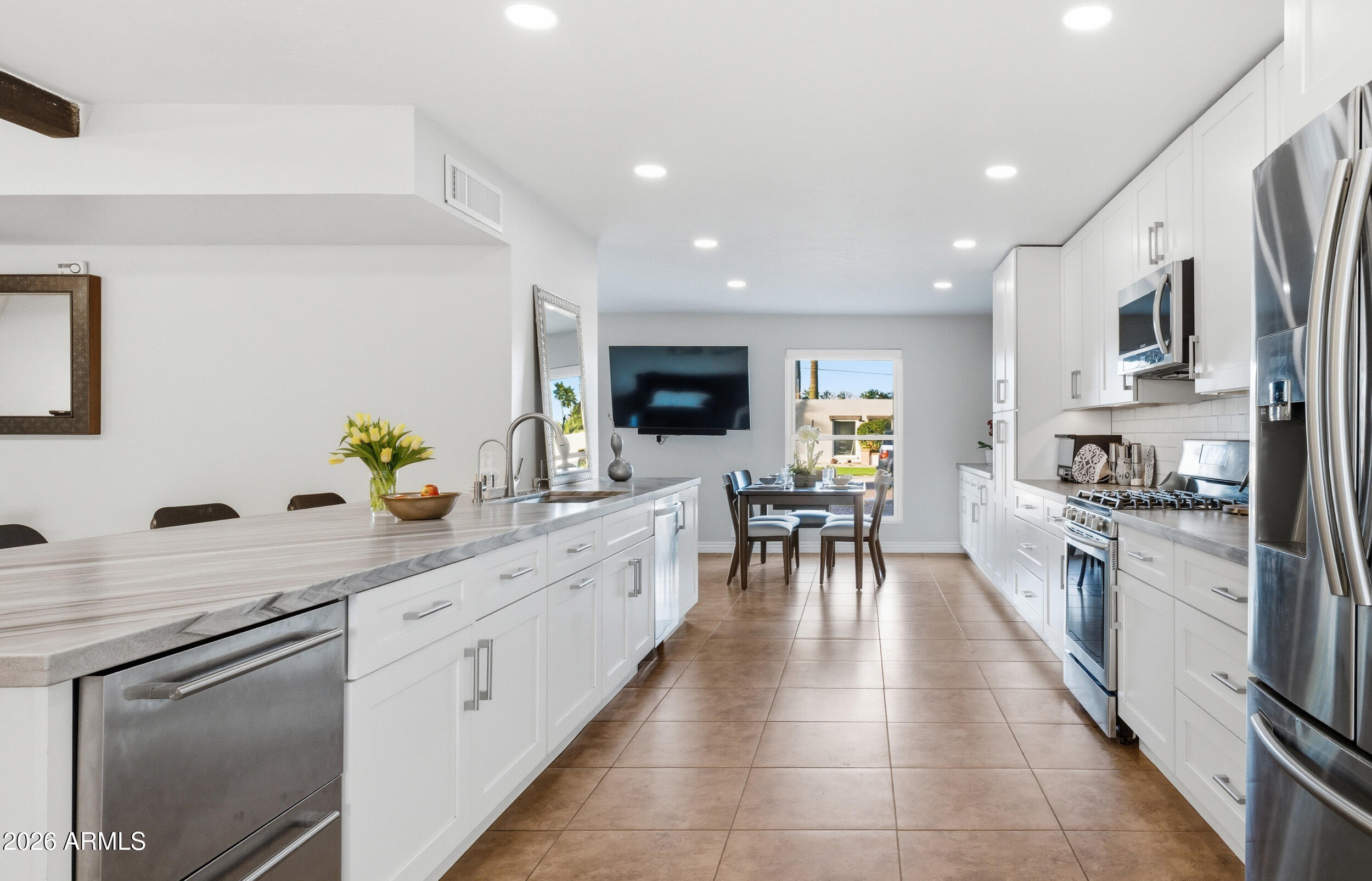 3541 East Cannon Drive Phoenix, AZ 85028 - Photo 2 of 42 a kitchen with stainless steel appliances kitchen island granite countertop a sink counter space and cabinets