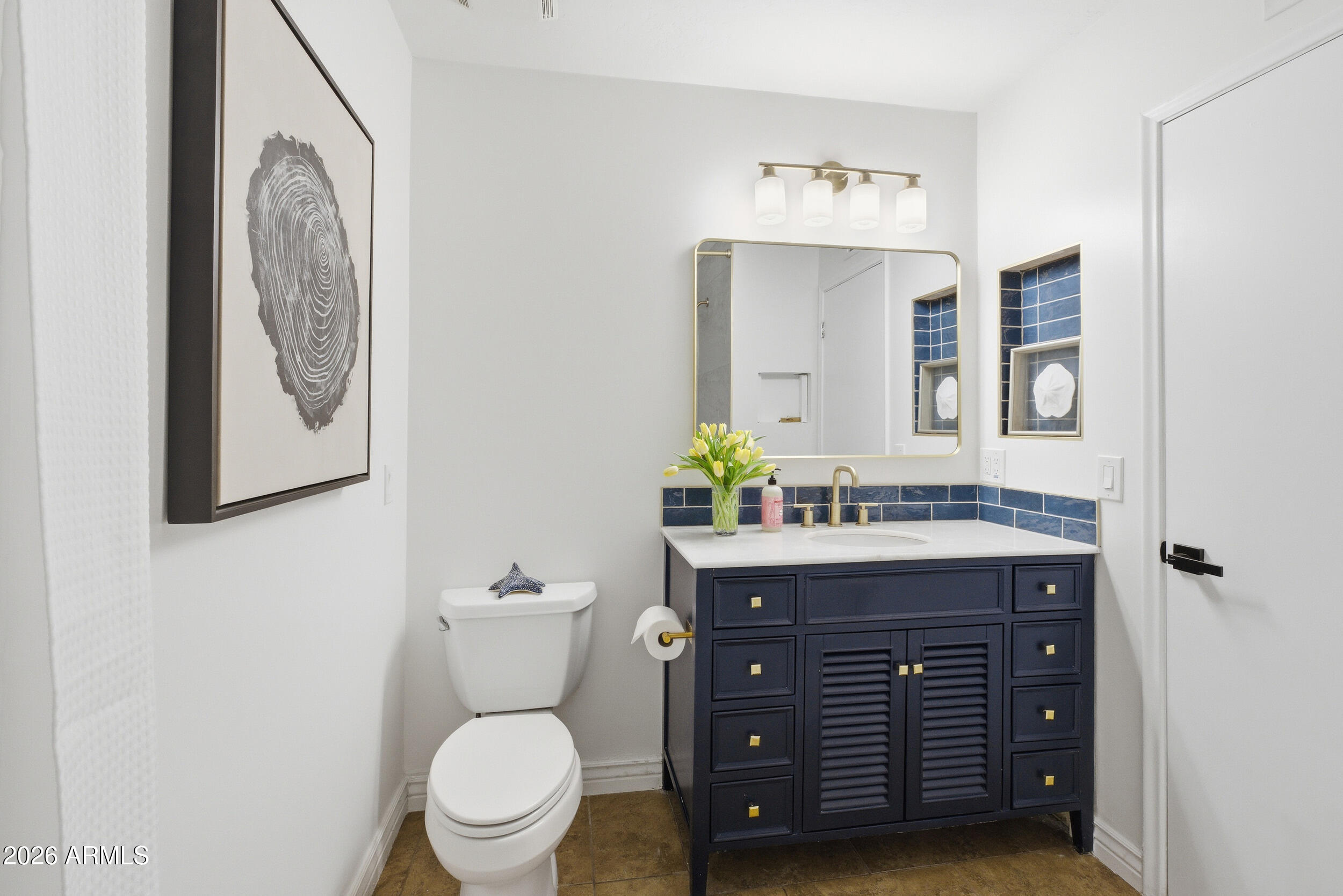 3541 East Cannon Drive Phoenix, AZ 85028 - Photo 29 of 42 a bathroom with a granite countertop toilet sink and mirror