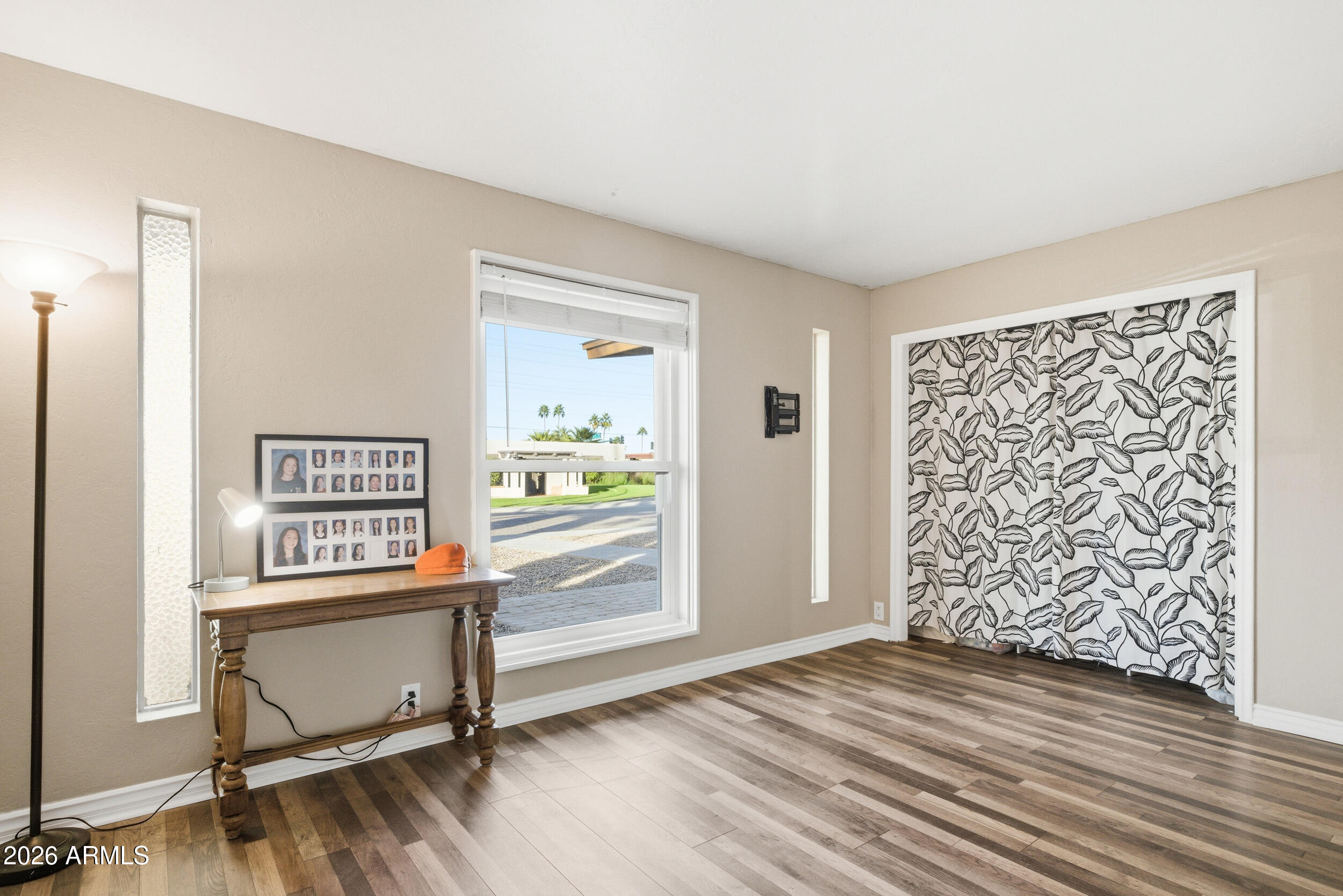 3541 East Cannon Drive Phoenix, AZ 85028 - Photo 33 of 42 an empty room with window and a wooden floor