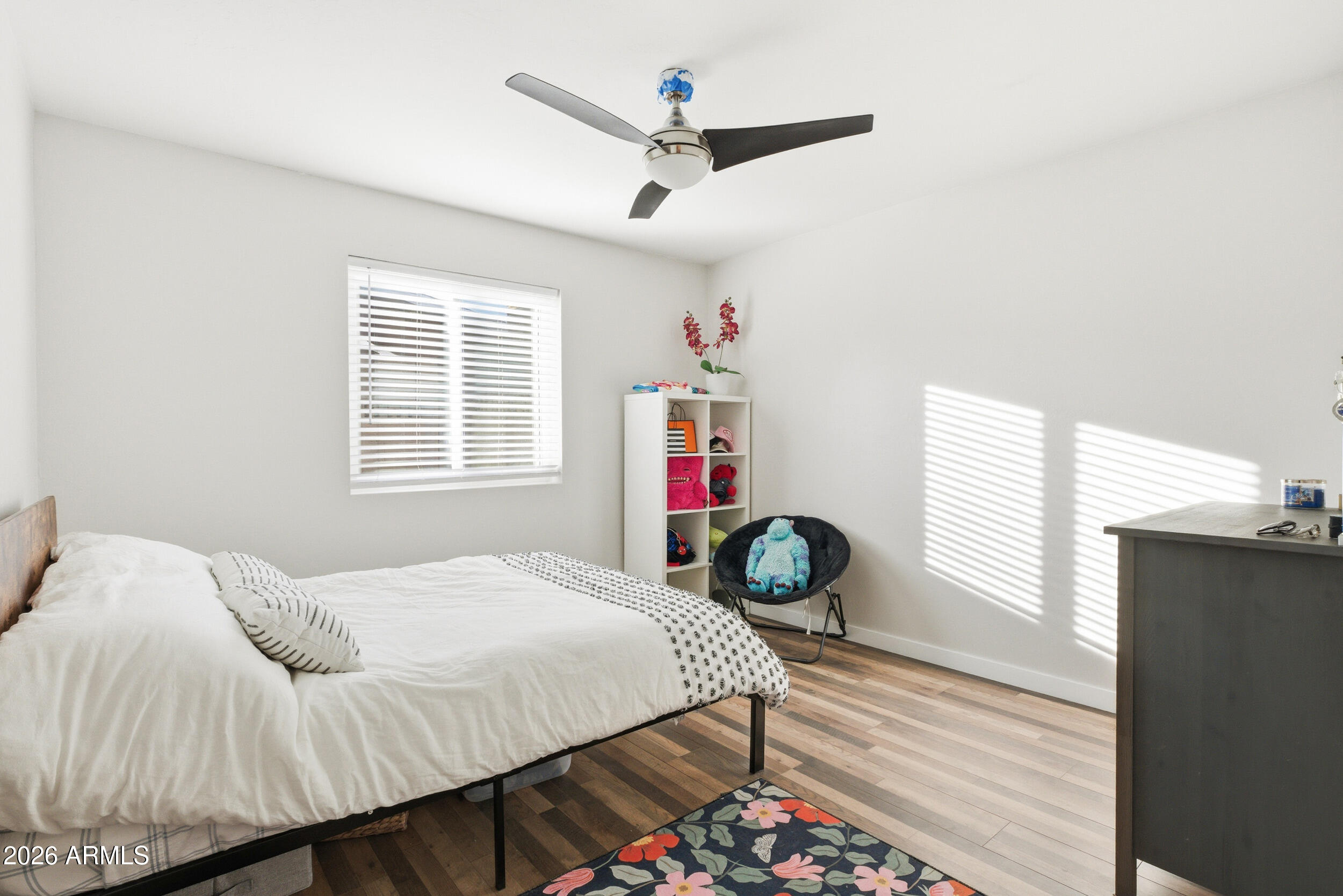 3541 East Cannon Drive Phoenix, AZ 85028 - Photo 10 of 42 a bedroom with a bed a dresser and wooden floor