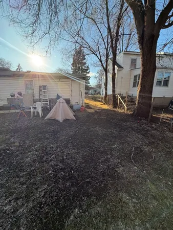 a view of yard covered with snow in front of house