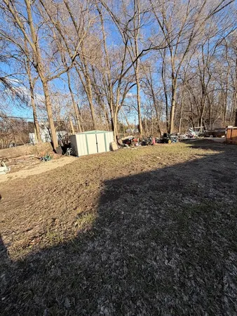 a view of yard with swimming pool and trees