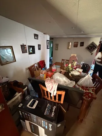 a room with lots of furniture and clutter