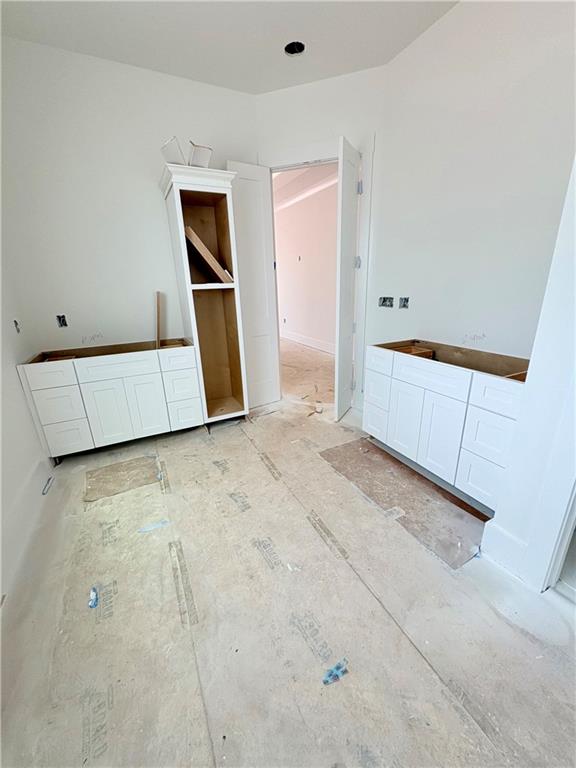 4013 Jersey Covington Road Covington, GA 30014 - Photo 11 of 29 an empty room with wooden floor and mirror