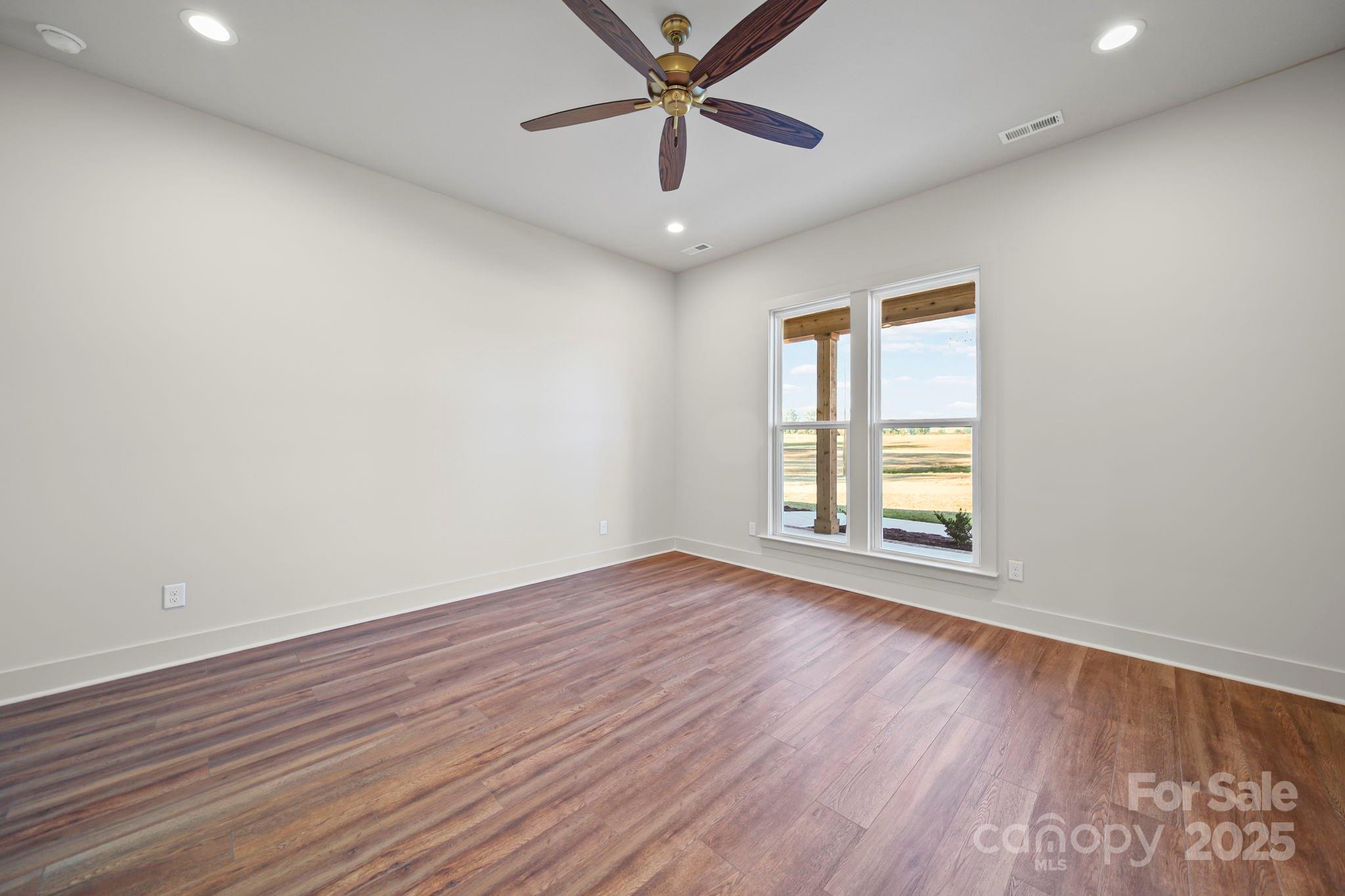 2417 Plyler Mill Road Monroe, NC 28112 - Photo 11 of 34 wooden floor in an empty room with a window