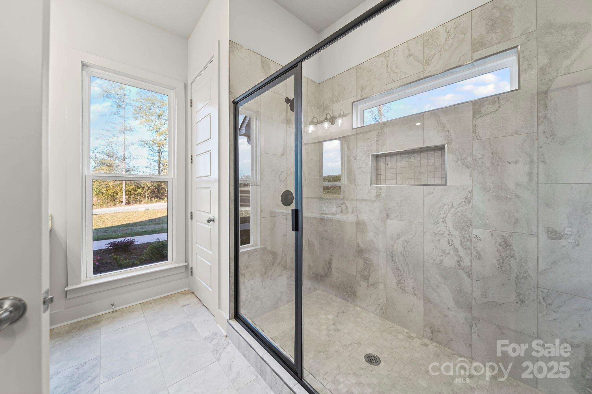 2417 Plyler Mill Road Monroe, NC 28112 - Photo 12 of 34 a bathroom with a glass shower door