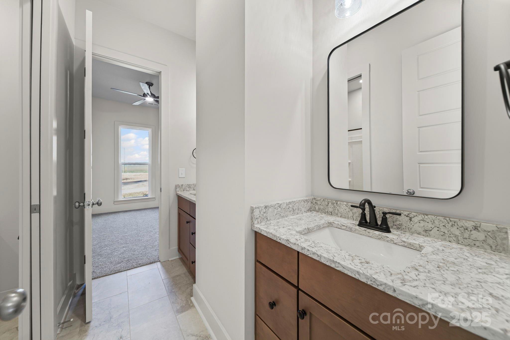 2417 Plyler Mill Road Monroe, NC 28112 - Photo 18 of 34 a bathroom with a granite countertop sink and a mirror