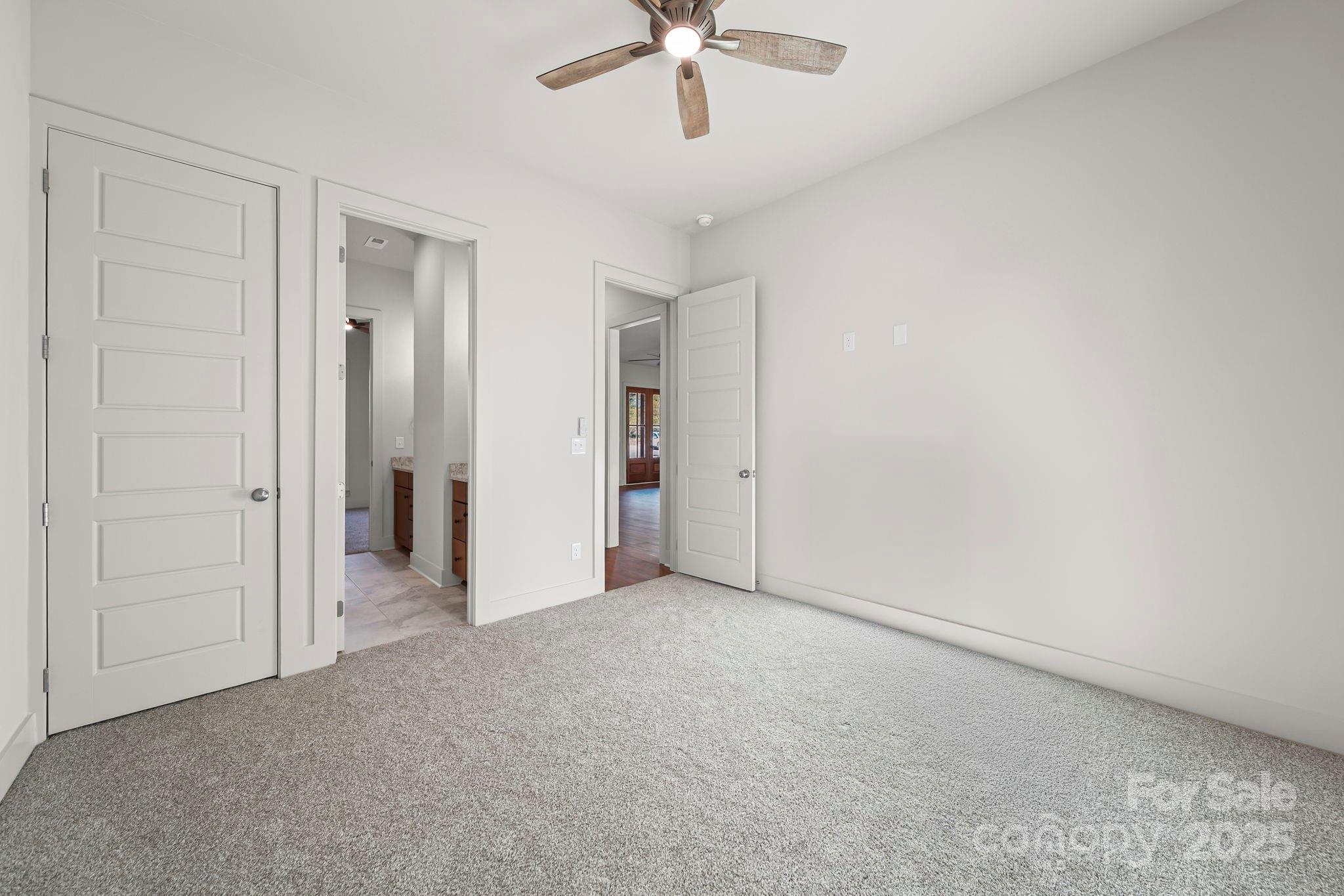 2417 Plyler Mill Road Monroe, NC 28112 - Photo 21 of 34 an empty room with chandelier fan and closet area