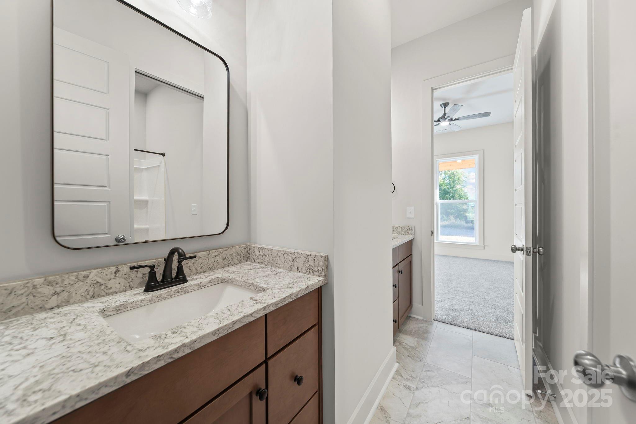2417 Plyler Mill Road Monroe, NC 28112 - Photo 23 of 34 a bathroom with a granite countertop sink and a mirror