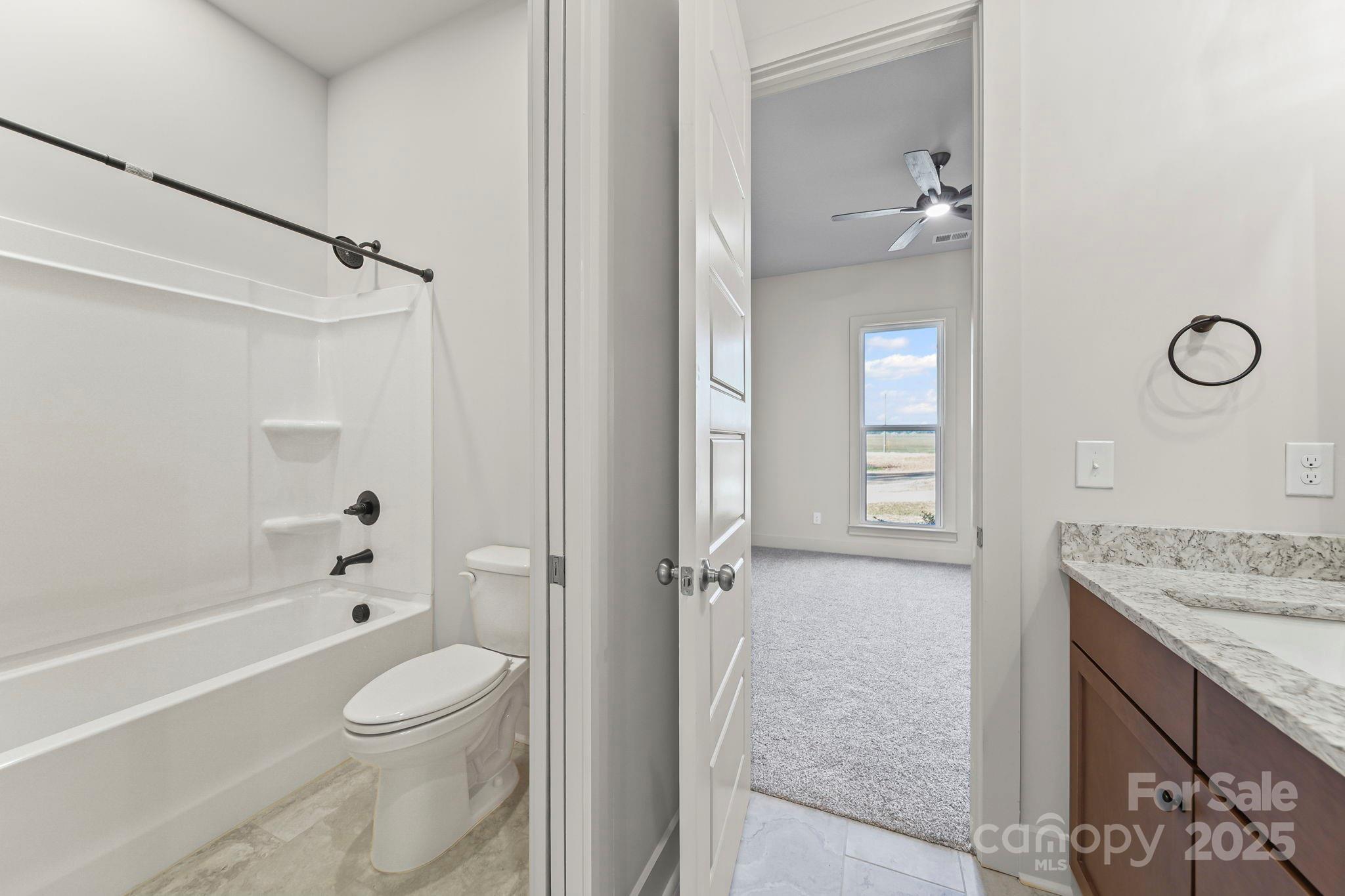 2417 Plyler Mill Road Monroe, NC 28112 - Photo 24 of 34 a bathroom with a granite countertop sink a toilet and shower