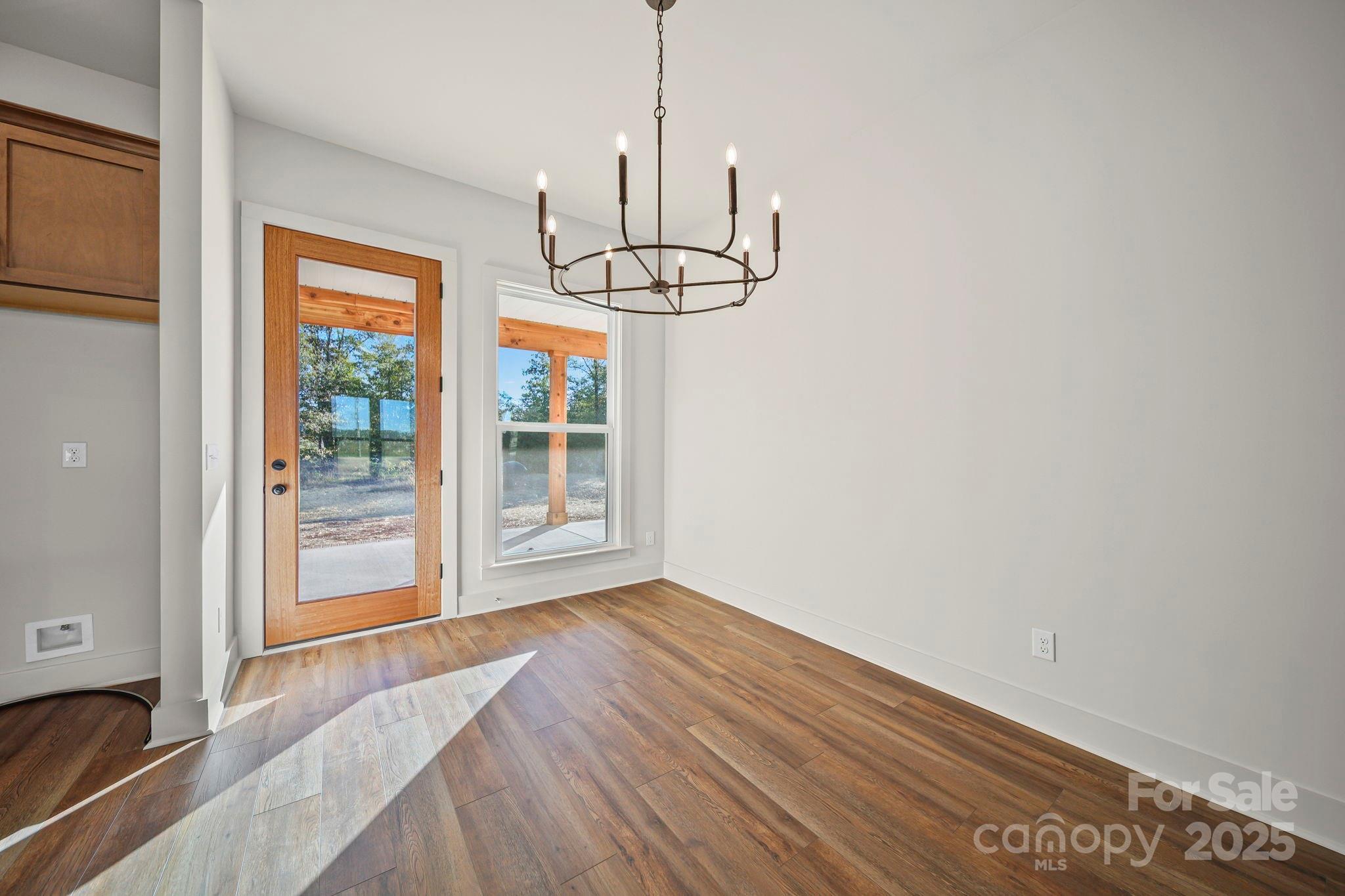 2417 Plyler Mill Road Monroe, NC 28112 - Photo 26 of 34 a view of wooden floor and a chandelier in a room