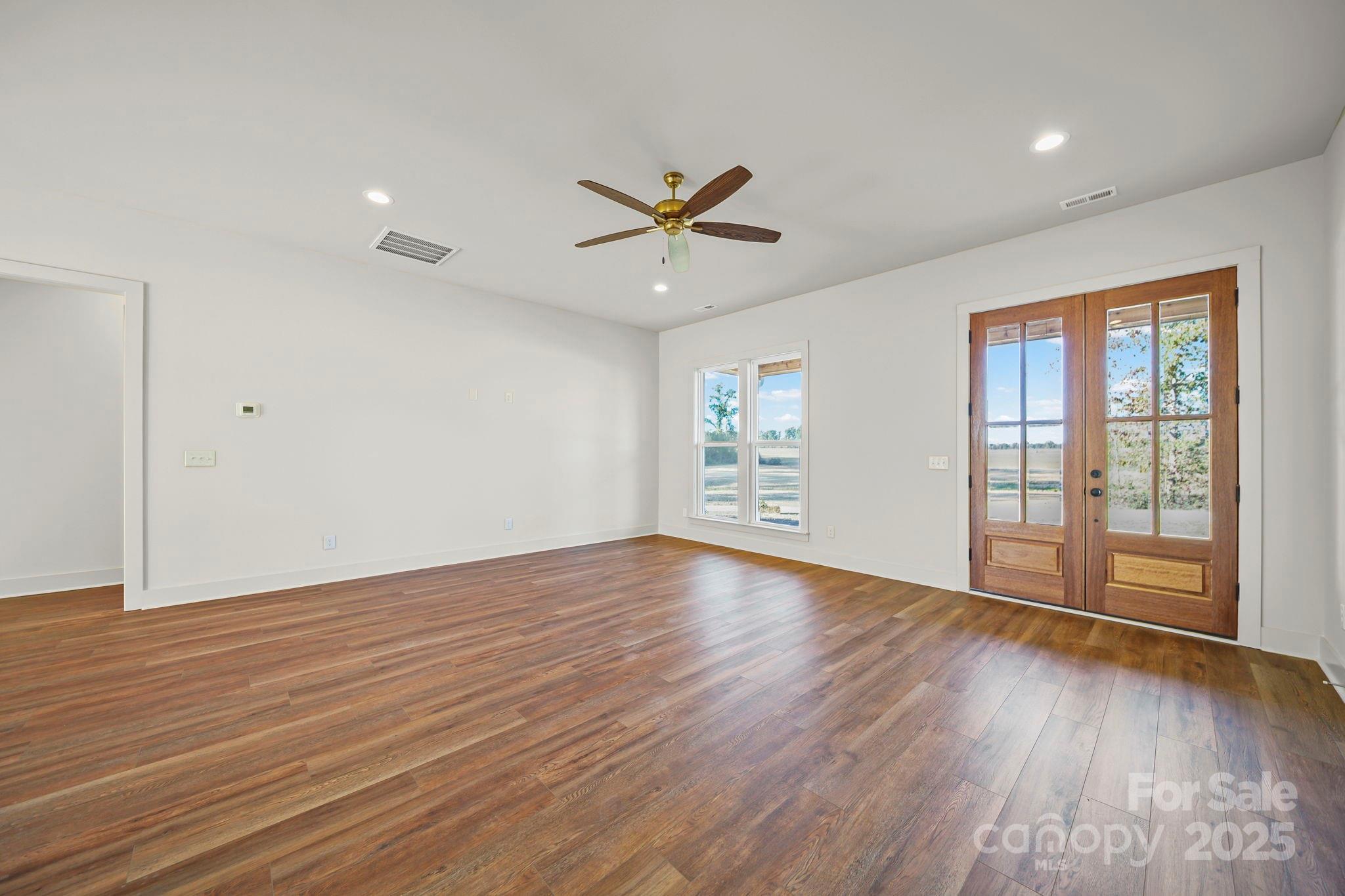 2417 Plyler Mill Road Monroe, NC 28112 - Photo 33 of 34 wooden floor in an empty room with a window