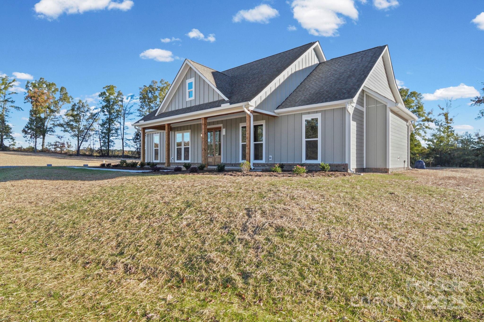 2417 Plyler Mill Road Monroe, NC 28112 - Photo 4 of 34 a front view of a house with a yard
