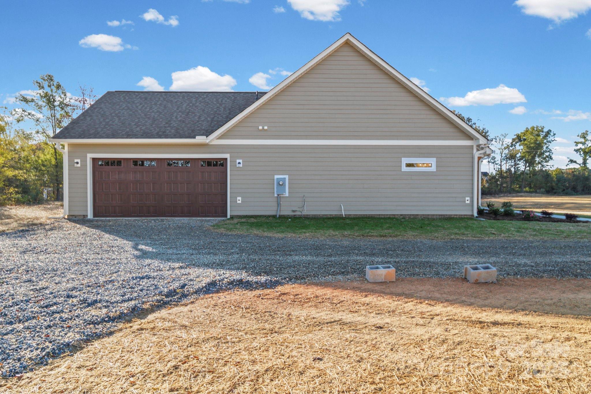 2417 Plyler Mill Road Monroe, NC 28112 - Photo 6 of 34 a front view of a house with a yard and garage