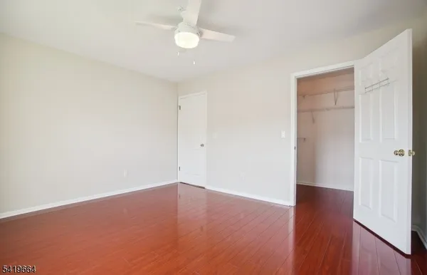 an empty room with wooden floor and closet