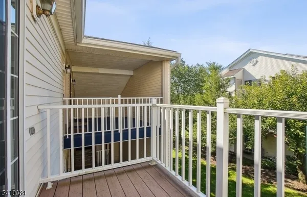 a view of a balcony with wooden floor
