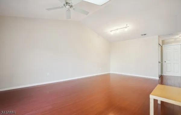 an empty room with a ceiling fan and a window