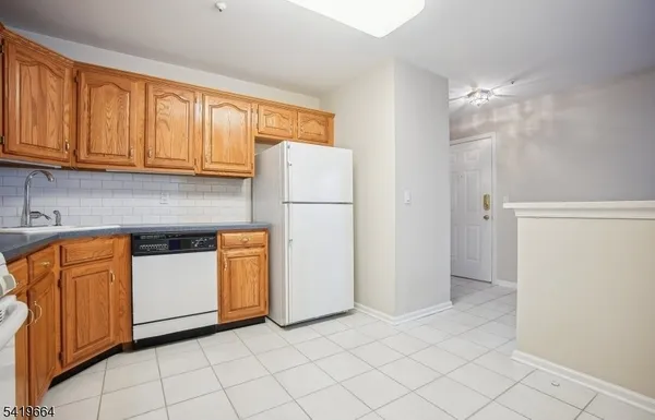 a kitchen with stainless steel appliances granite countertop a refrigerator sink and cabinets