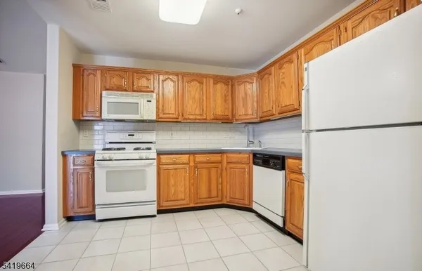 a kitchen with a stove a sink and a refrigerator