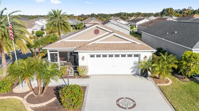 a view of a house with pool and sitting area