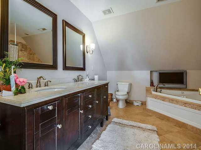 6713 Potter Road Waxhaw, NC 28173 - Photo 9 of 16 a spacious bathroom with a double vanity sink and a mirror