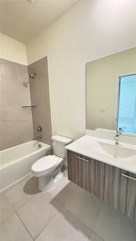 a bathroom with a double vanity sink toilet mirror and bathtub