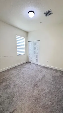 an empty room with a empty space and windows