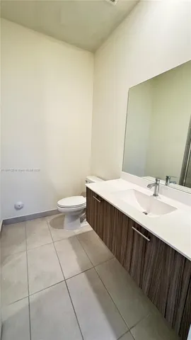a bathroom with a sink a toilet and mirror