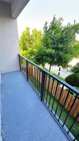 a view of a balcony with wooden fence