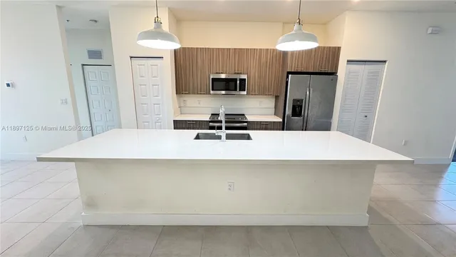 a kitchen with a microwave a refrigerator and a stove