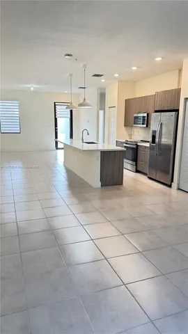 a large kitchen with stainless steel appliances kitchen island granite countertop a large counter top and oven