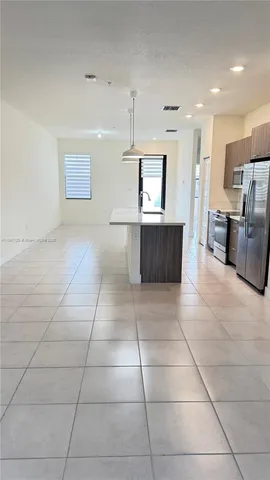a kitchen with a sink a counter top space appliances and cabinets