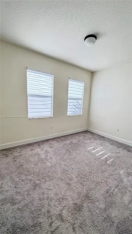an empty room with a empty space and windows