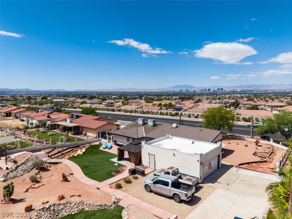 892 North Hollywood Boulevard Las Vegas, NV 89110 - Photo 63 of 81 An aerial view showcases a residential landscape with a distant city skyline under a vast sky.